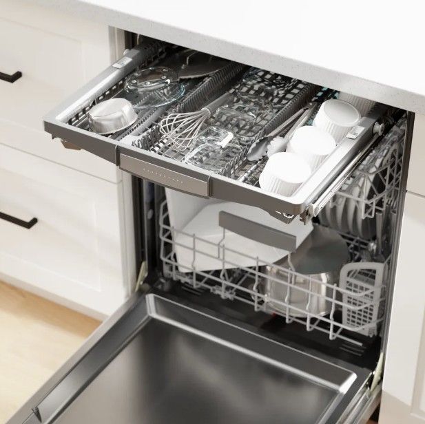 Interior of a modern dishwasher featuring a third rack for cutlery
