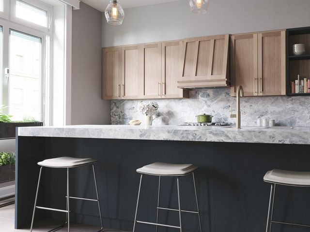 Modern kitchen with range hood insert installed in custom cabinetry