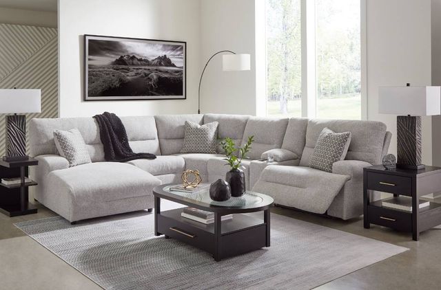 Front view of a modern living room with a grey sectional recliner 