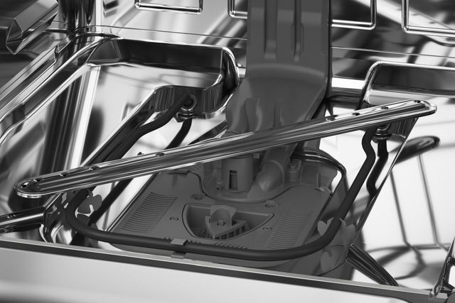 Close view of the inside of a stainless steel dishwasher Close view of the inside of a stainless steel dishwasher