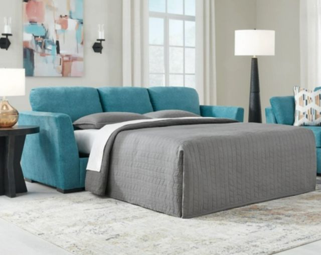 front view of a blue sofa bed with a white mattress in a modern living space