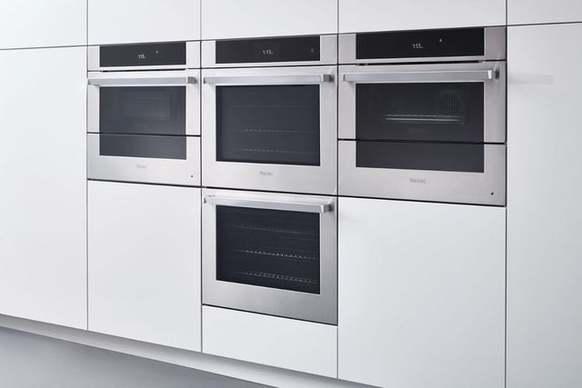 Front view of four Viking wall ovens on a white wall
