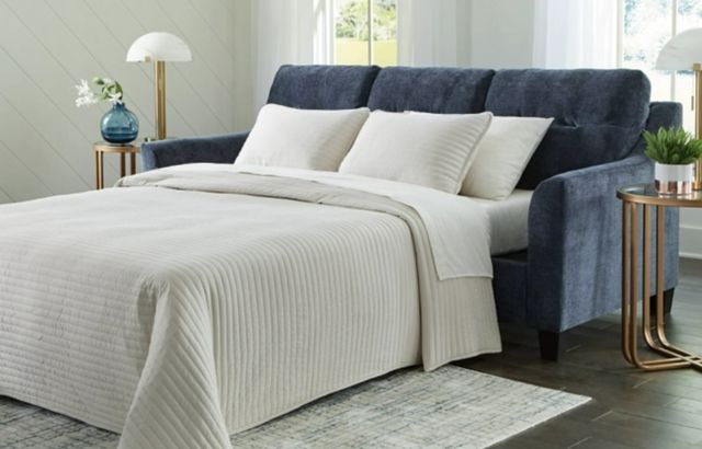 front view of a blue sofa bed with a white queen mattress