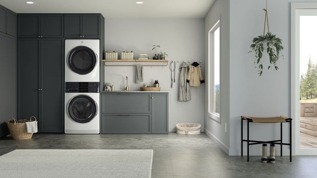 Front view of a modern laundry room with an Electrolux stacked washer dryer 