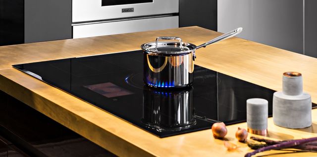 close view of a dacor cooktop with a pot cooking on top