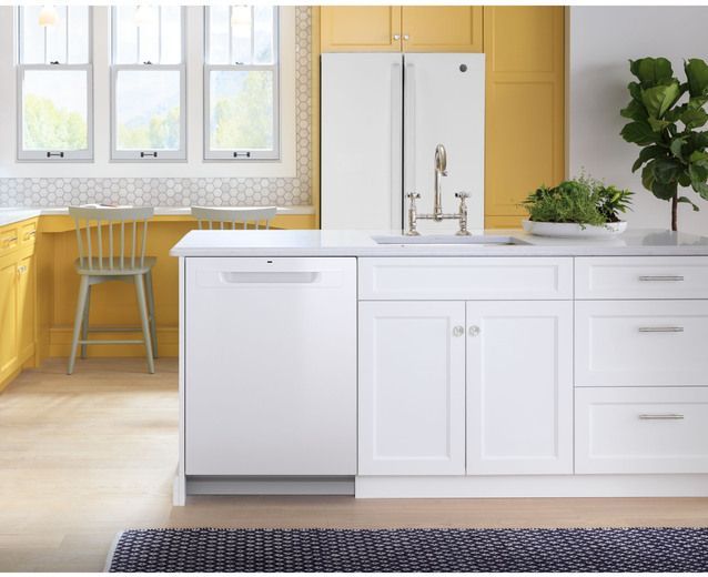 Integrated white dishwasher in a modern kitchen with white cabinetry