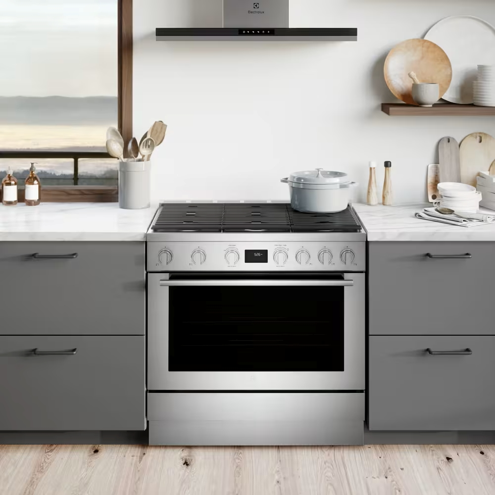 woman cooking in kitchen with gas stove