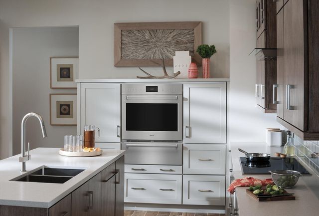 Front view of a modern kitchen with a Wolf E Series wall oven