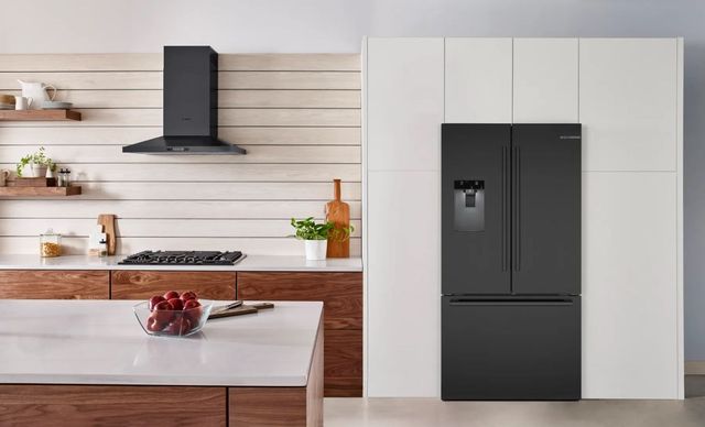 Modern kitchen featuring a sleek black stainless steel refrigerator