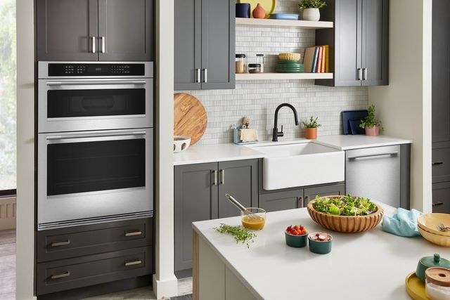 Front view of a modern kitchen with a KitchenAid wall oven and microwave combo